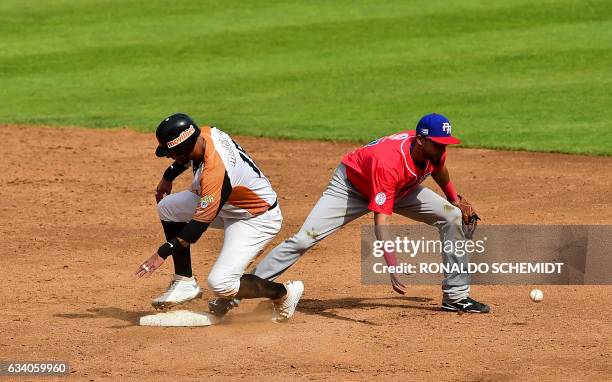 Ronny Cedeno of Aguilas del Zulia of Venezuela slides safe in second base during a Caribbean Baseball Series match against Criollos de Caguas from...