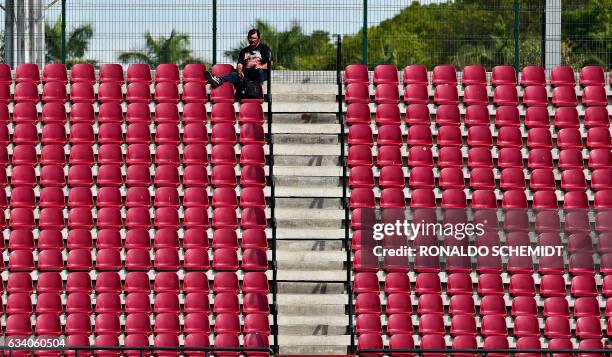 Man watches a Caribbean Baseball Series match between Aguilas del Zulia of Venezuela and Criollos de Caguas of Puerto Rico at the Tomateros stadium...