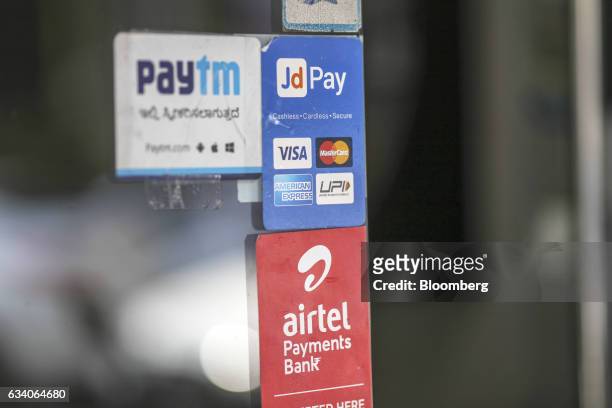 Signage for digital payments services Paytm, operated by One97 Communications Ltd., top left, JD Pay, operated by Just Dial Ltd., top right, and...