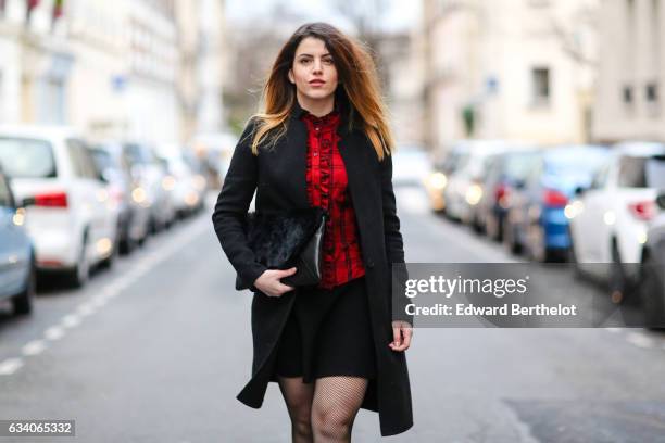 Sara Carnicella, fashion blogger from La Fille Rebelle, wears a Zara red top, a Zara black coat, a Nicoletta Parodi black clutch with fur, a Zara...