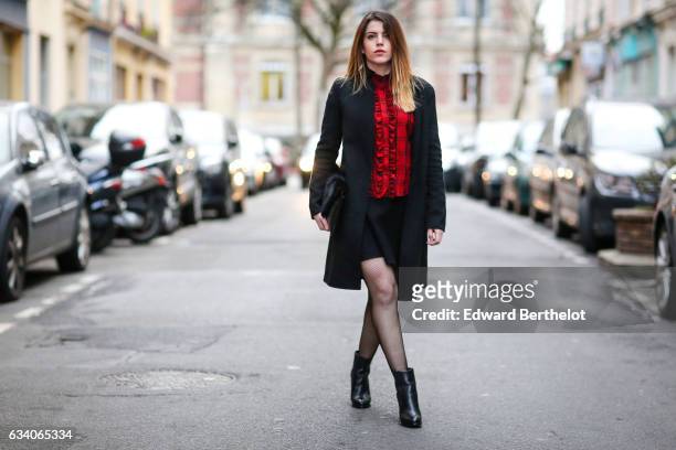Sara Carnicella, fashion blogger from La Fille Rebelle, wears a Zara red top, a Zara black coat, a Nicoletta Parodi black clutch with fur, a Zara...