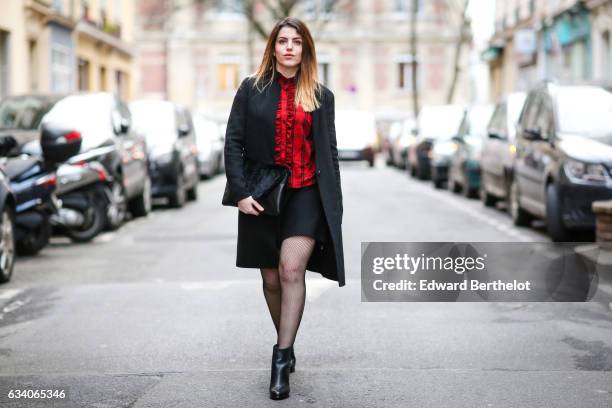 Sara Carnicella, fashion blogger from La Fille Rebelle, wears a Zara red top, a Zara black coat, a Nicoletta Parodi black clutch with fur, a Zara...