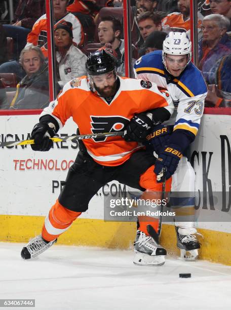 Radko Gudas of the Philadelphia Flyers pins Kenny Agostino of the St Louis Blues to the boards as they battle for the loose puck on February 6, 2017...