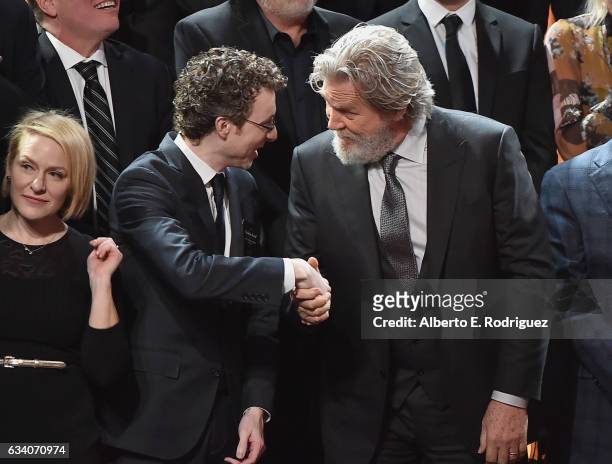 Producer Nicholas Britell greets actor Jeff Bridges during the 89th Annual Academy Awards Nominee Luncheon at The Beverly Hilton Hotel on February 6,...