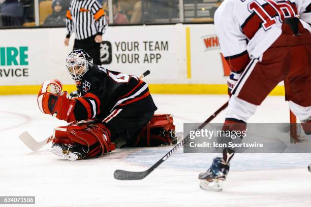 Northeastern University Huskies goaltender Ryan Ruck stretches out for a save but watches the puck go wide during the second period of the Beanpot...