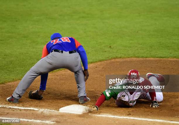 Christopher Roberson of Aguilas de Mexicali from Mexico slides safely into first base against Alazanes de Granma from Cuba in the semifinals of...