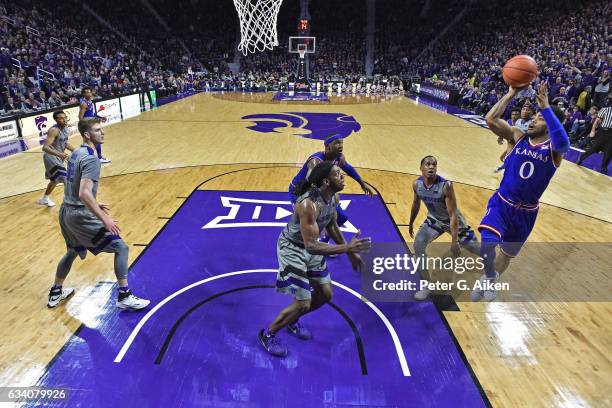 Guard Frank Mason III of the Kansas Jayhawks puts up a shot over forward D.J. Johnson of the Kansas State Wildcats during the second half on February...