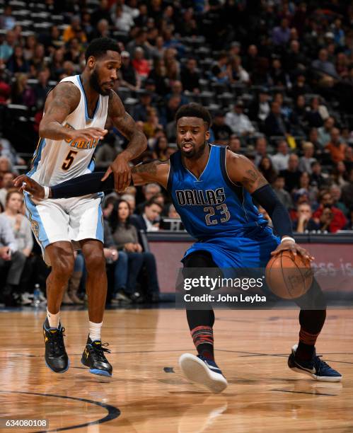 Denver Nuggets guard Will Barton grabs ahold of Dallas Mavericks guard Wesley Matthews as attempt to drive past him during the third quarter February...