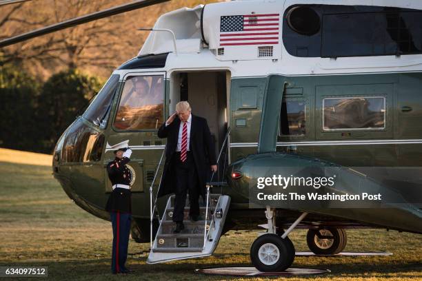 President Trump salutes as he disembarks Marine One on the South Lawn of the White House in Washington, DC on Monday, Feb. 06, 2017. Trump returns...