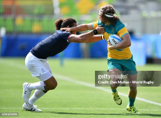 Lewis Holland of Australia is tackled by Pierre Gilles Lakafia of France during the Men's Rugby Sevens Pool B match between Australia and France on...