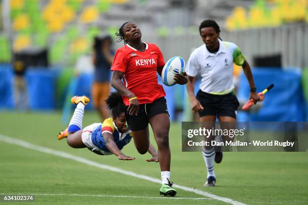 Janet Okelo of Kenya makes a break past Khaterinne Medina of Colombia to score a try during the Women's Rugby Sevens placing match between Colombia...