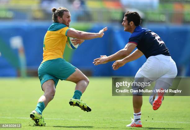 Lewis Holland of Australia takes on Manoel Dall Igna of France during the Men's Rugby Sevens Pool B match between Australia and France on Day 4 of...