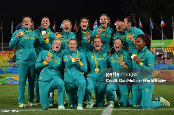 The Australia team pose with their gold medals following victory during the Women's Rugby Sevens Gold Medal match between Australia and New Zealand...