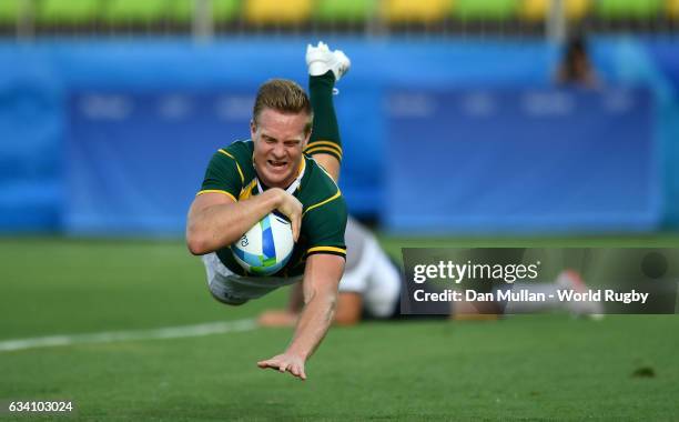 Dylan Sage of South Africa dives over for a try during the Men's Rugby Sevens Pool B match between South Africa and France on Day 4 of the Rio 2016...