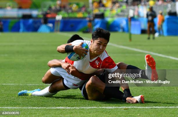 Kazushi Hano of Japan dives over for a try during the Men's Rugby Sevens Pool C match between New Zealand and Japan on Day 4 of the Rio 2016 Olympic...