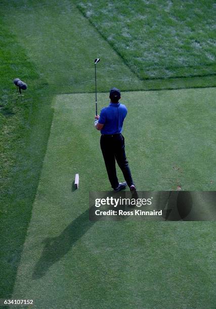 Tiger Woods o f the USA watches his tee shot on the 16th tee during the first round of the Omega Dubai Desert Classic at Emirates Golf Club on...