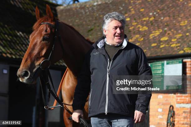 Champion jump trainer Paul Nicholls poses alongside Movewiththetimes during a media day at Manor Farm Stables on February 7, 2017 in Ditcheat,...