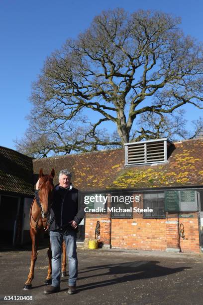 Champion jump trainer Paul Nicholls poses alongside Movewiththetimes during a media day at Manor Farm Stables on February 7, 2017 in Ditcheat,...