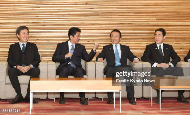 Japanese Foreign Minister Fumio Kishida attends a Cabinet meeting in Tokyo on Feb. 7 alongside Nobuteru Ishihara, minister in charge of economic...
