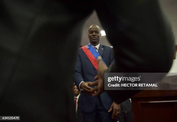 New Haitian President Jovenel Moïse shakes hands after receiving his sash during his Inauguration, at the Haitian Parliament in Port-au-Prince, on...