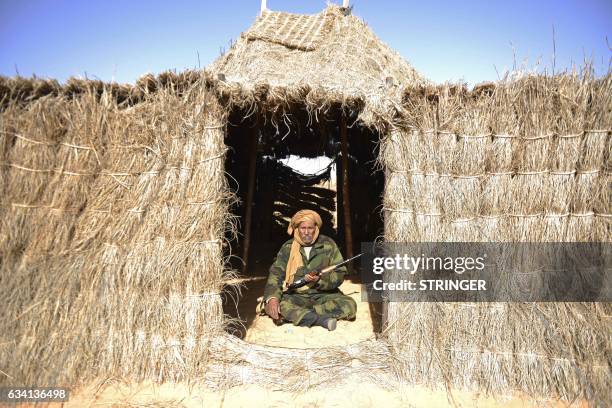 Bechir Mohamed, the chief of security in the Al-Mahbes area in the Western Sahara poses for a photo inside his hut on February 3, 2017. - It is the...