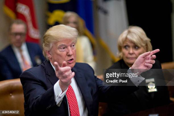 President Donald Trump speaks as he meets with county sheriffs including Carolyn Welsh, sheriff from Chester County, Pennsylvania, right, during a...