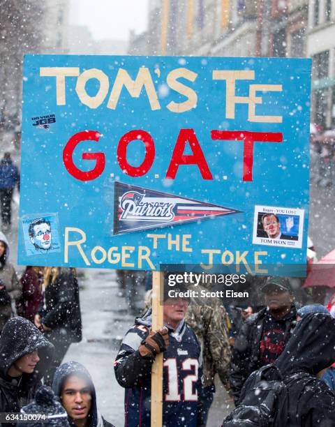 Fan holds a sign that reads "Tom's the Goat, Roger the Joke" during the New England Patriots victory parade on February 7, 2017 in Boston,...