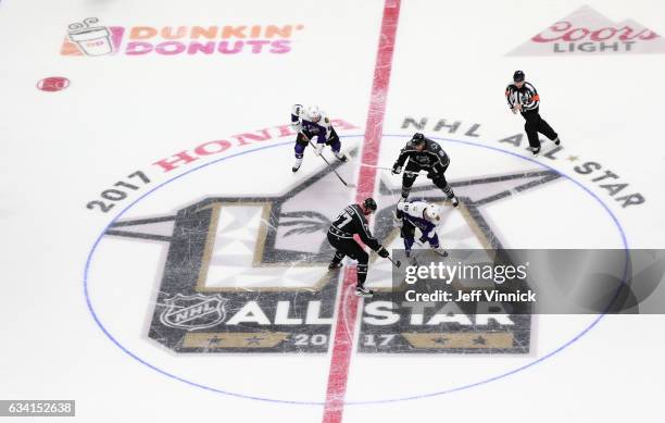 Jonathan Toews of the Chicago Blackhawks and Jeff Carter of the Los Angeles Kings take the opeing face-off of the 2017 Honda NHL All-Star Game at...
