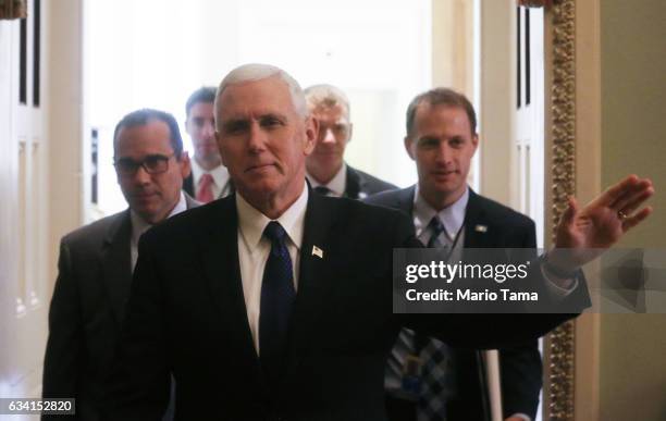 Vice President Mike Pence waves while leaving a Senate policy luncheon after the Senate voted to confirm Betsy DeVos as education secretary on...