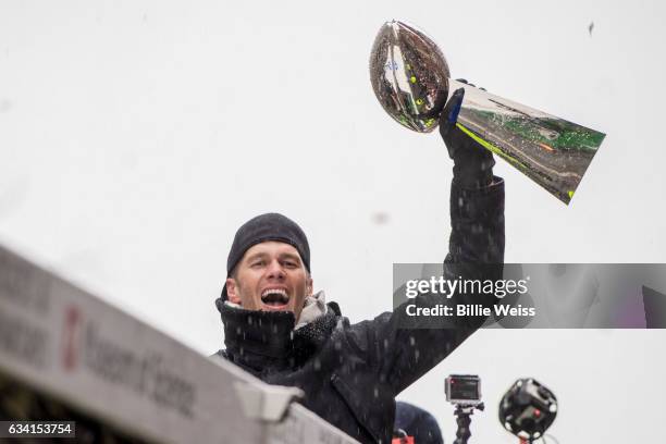 Quarterback Tom Brady of the New England Patriots holds the Vince Lombardi trophy during the Super Bowl victory parade on February 7, 2017 in Boston,...