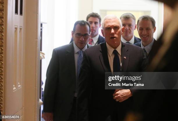 Vice President Mike Pence leaves a Senate policy luncheon after the Senate voted to confirm Betsy DeVos as education secretary on Capitol Hill on...