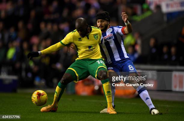 Youssouf Mulumbu of Norwich is tackled by Sam Morsy of Wigan during the Sky Bet Championship match between Wigan Athletic and Norwich City at DW...