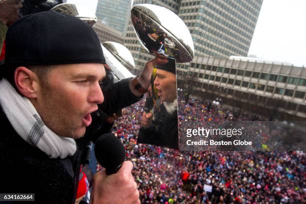 New England Patriots quarterback Tom Brady raises a Lombardi Trophy during the rally in City Hall Plaza following the Patriots Super Bowl LI Victory...