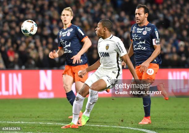 Monaco's French forward Kylian Mbappe Lottin vies with Montpellier's Brazilian defender Victorio Hilton and Montpellier's Czech defender Lukas...