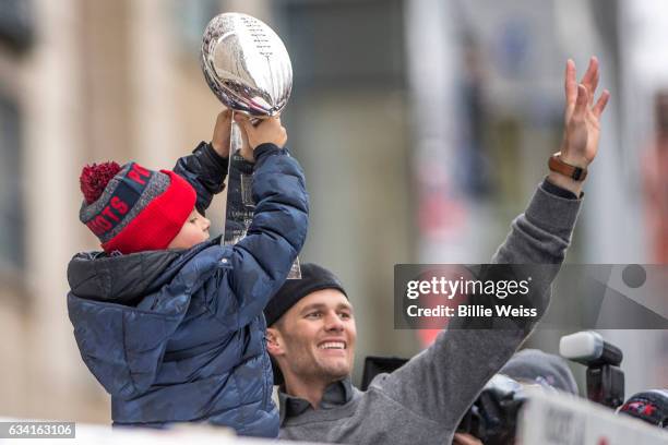 Tom Brady of the New England Patriots celebrates with his son Benjamin during the Super Bowl victory parade on February 7, 2017 in Boston,...