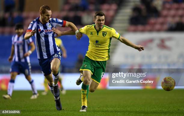 Jonny Howson of Norwich holds off Shaun MacDonald of Wigan during the Sky Bet Championship match between Wigan Athletic and Norwich City at DW...