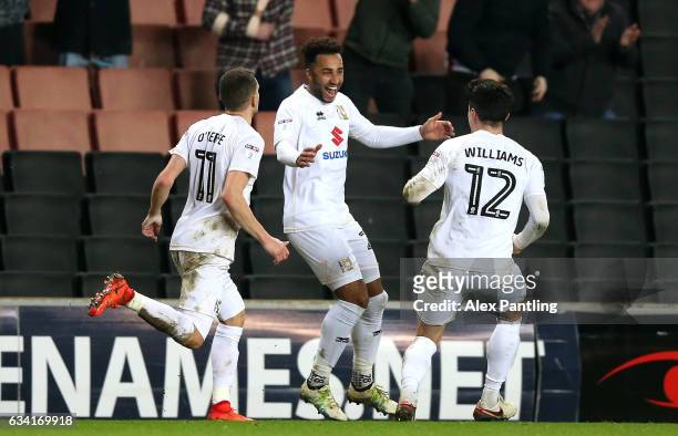 Nicky Maynard of MK Dons celebrates scoring his sides first goal with team mates during the Sky Bet League One match between Milton Keynes Dons and...