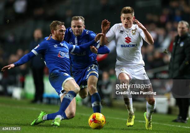 Harvey Barnes of MK Dons rides a tackle from Paul Green of Oldham Athletic during the Sky Bet League One match between Milton Keynes Dons and Oldham...