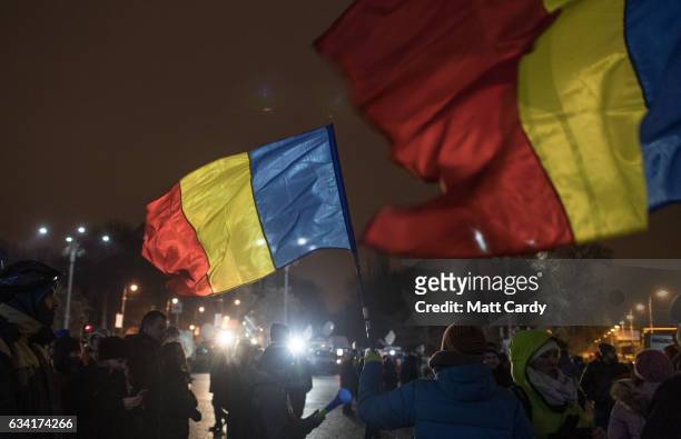 People demonstrate and protest in front of the government headquarters in Victory Square in central Bucharest on February 7, 2017 in Bucharest,...
