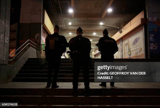 French policemen stand guard at the Rose des Vents district also known as the Cite des 3000 in Aulnay-sous-Bois, northeast of Paris on February 7,...