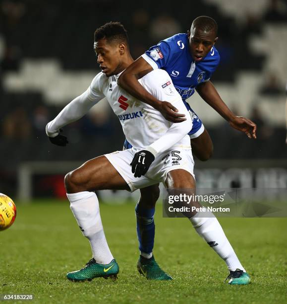 Chuks Aneke of Milton Keynes Dons looks to the ball under pressure from Ousmane Fane of Oldham Athletic holds the ball during the Sky Bet League One...