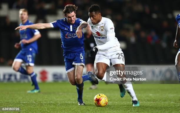 Chuks Aneke of Milton Keynes Dons attempts to move away with the ball under pressure from Aiden O'Neill of Oldham Athletic during the Sky Bet League...