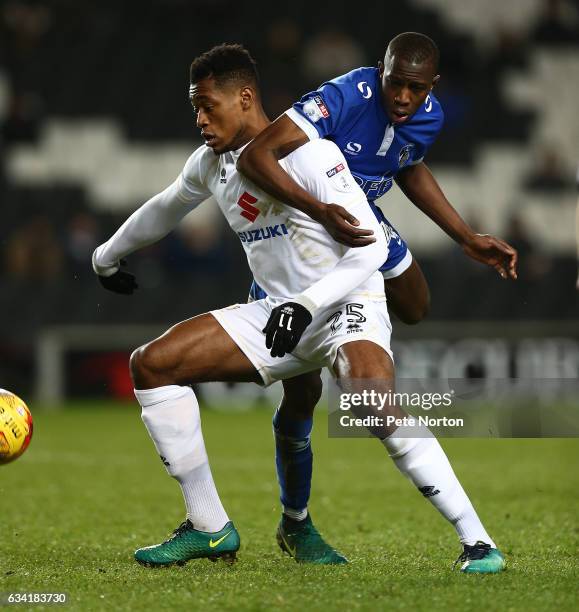 Chuks Aneke of Milton Keynes Dons looks to the ball under pressure from Ousmane Fane of Oldham Athletic holds the ball during the Sky Bet League One...