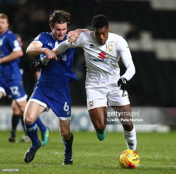 Chuks Aneke of Milton Keynes Dons attempts to move away with the ball under pressure from Aiden O'Neill of Oldham Athletic during the Sky Bet League...