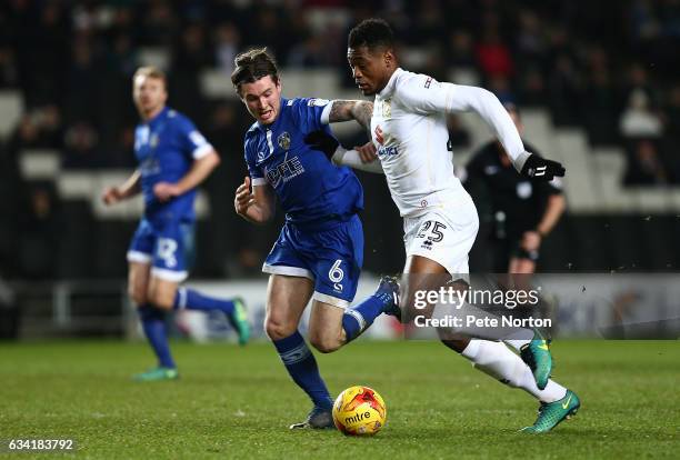 Chuks Aneke of Milton Keynes Dons attempts to move away with the ball under pressure from Aiden O'Neill of Oldham Athletic during the Sky Bet League...