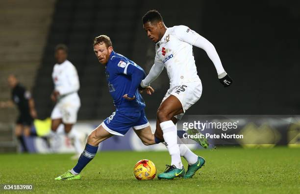 Chuks Aneke of Milton Keynes Dons attempts to move forward with the ball watched by Paul Green of Oldham Athletic during the Sky Bet League One match...