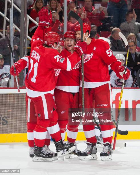 Dylan Larkin, Tomas Tatar and Jonathan Ericsson of the Detroit Red Wings celebrate with teammate Nick Jensen after he scores the first goal of an NHL...