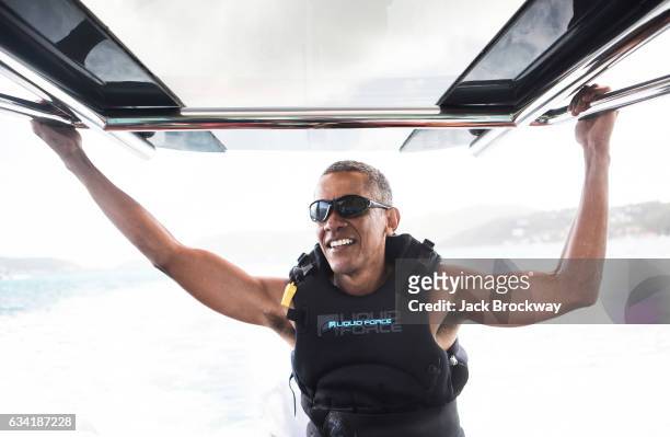 In this undated image former President Barack Obama takes a break from learning to kitesurf at Richard Branson's Necker Island retreat on February 1,...
