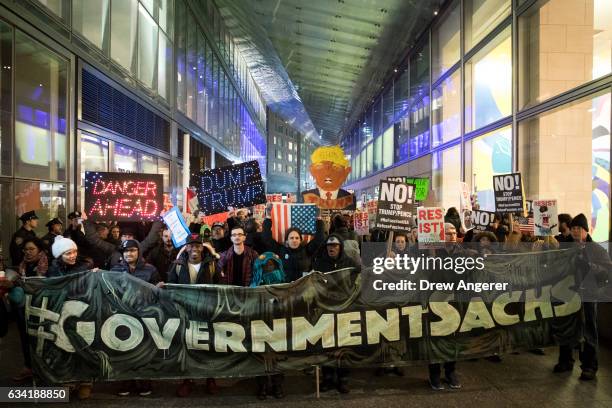 Activists rally against President Donald Trump's reported plans to loosen Wall Street Regulations and repeal the Dodd-Frank Act outside of Goldman...