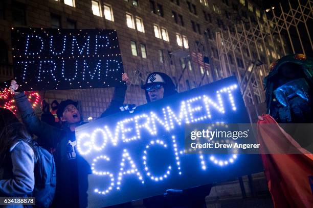 Activists rally against President Donald Trump's reported plans to loosen Wall Street Regulations and repeal the Dodd-Frank Act as they march toward...